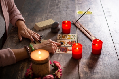 hand on tarot cards while reading