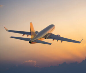 Aeroplane is flying in sky above clouds