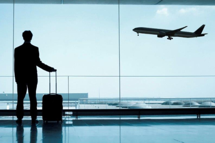 Aeroplane a man with suitcase standing in airpport, Videsh yatra